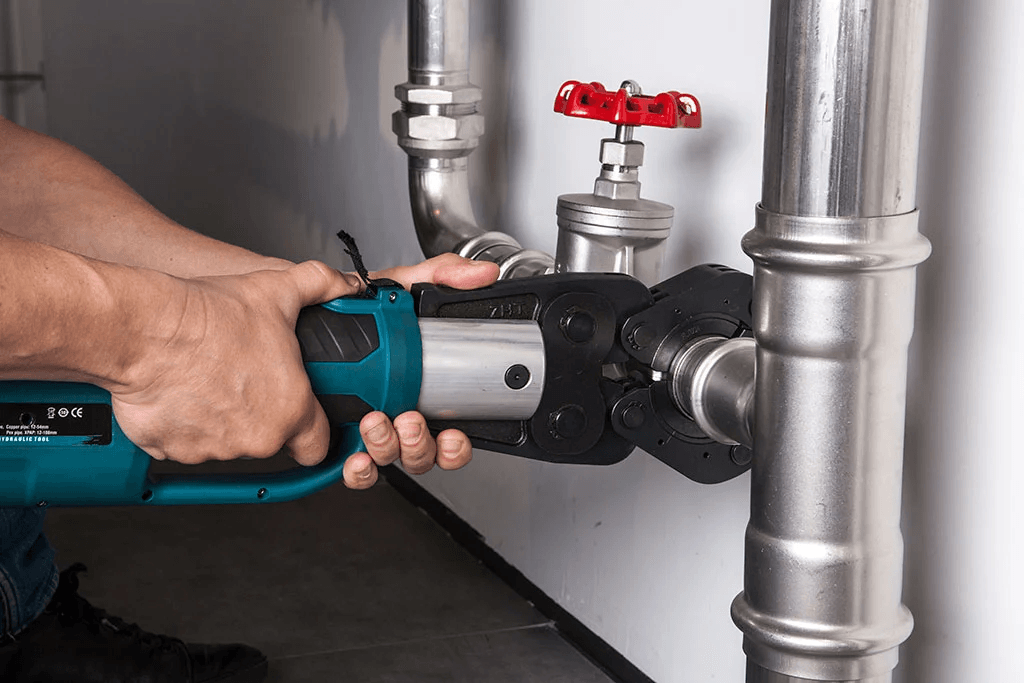 Press gun being used on some pipe